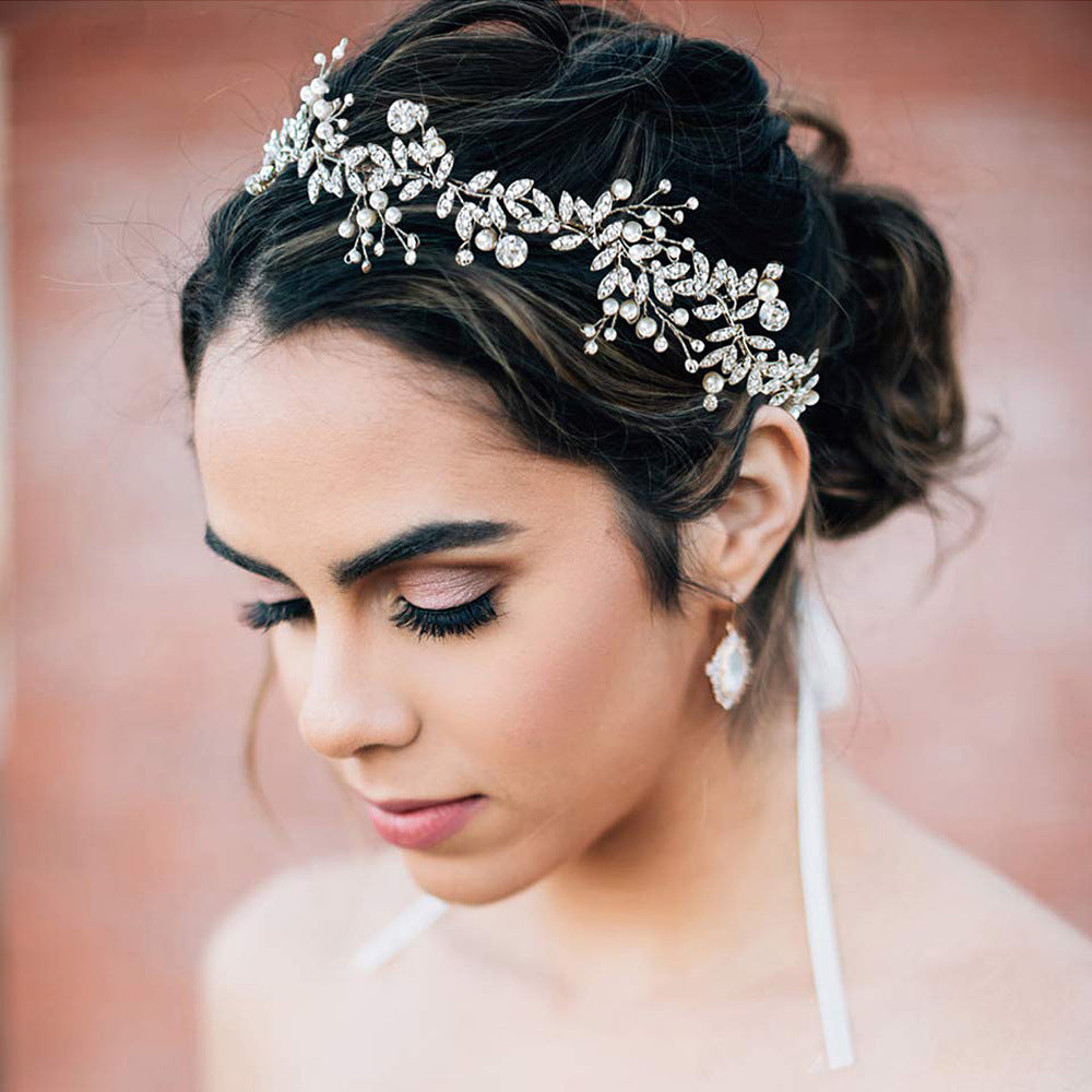 Bridal hair band with rhinestone embellishments in a wave shape design.