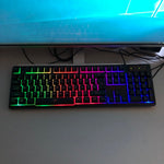 Black light keyboard with RGB backlit keys, slim and ergonomic design for smooth and quiet typing.