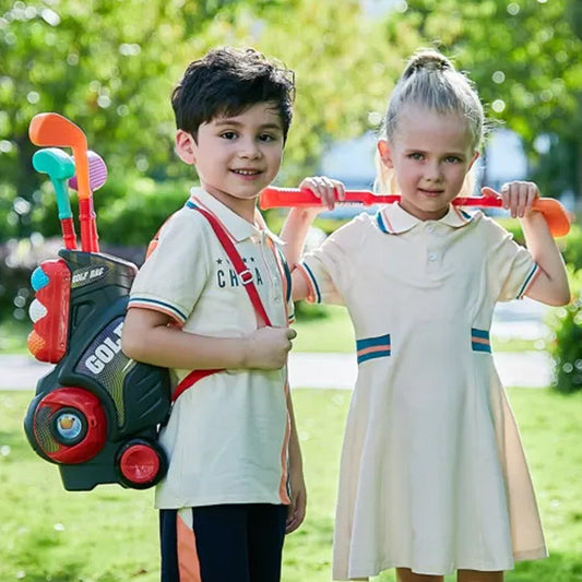 Children playing with a colorful trolley box golf toy club set outdoors.