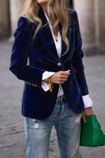 Woman wearing navy one button lapel collar long sleeve blazer with white shirt and green handbag