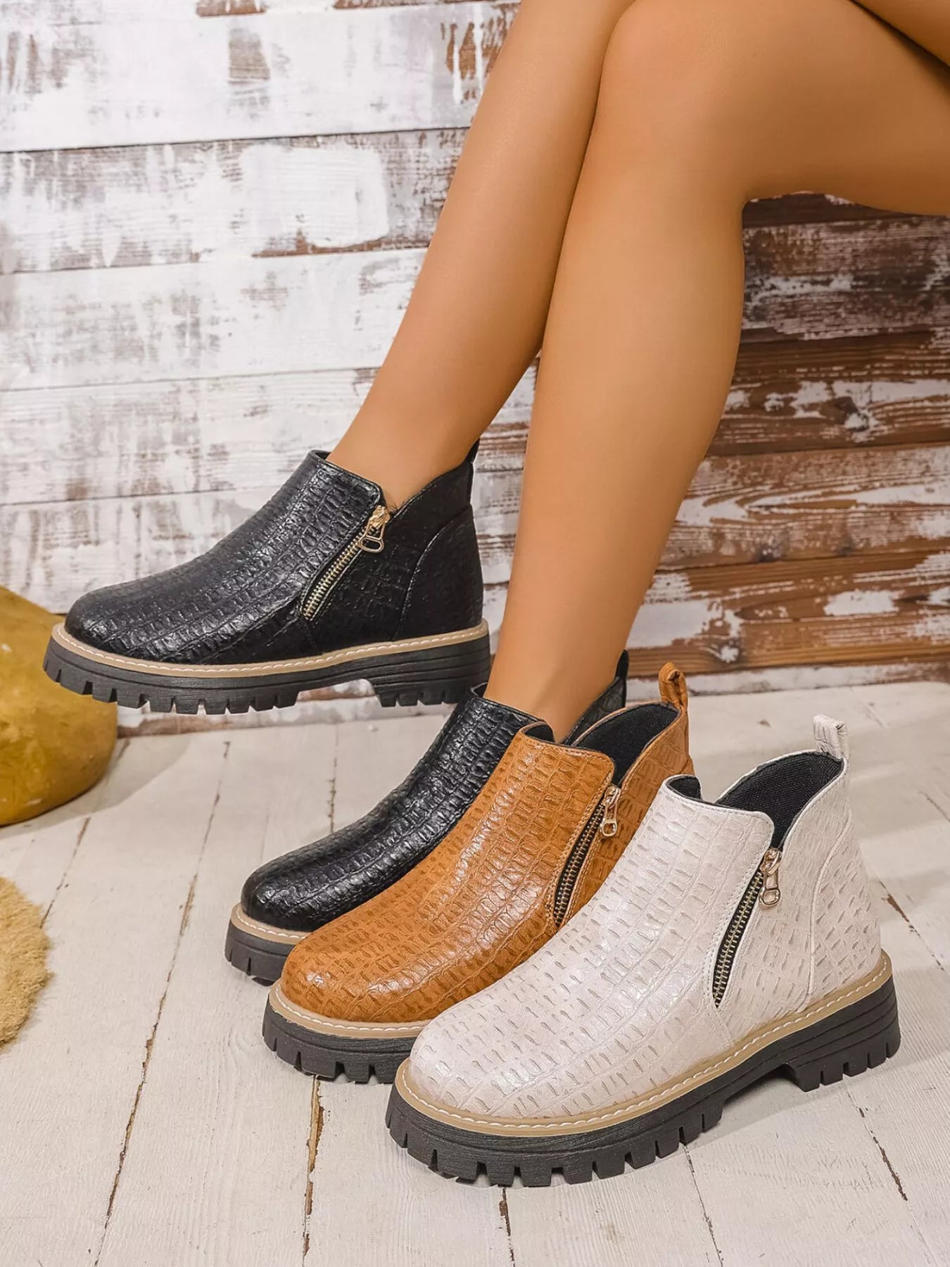 Round toe side zip ankle boots in black, brown, and white PU leather with low heels and rubber soles.