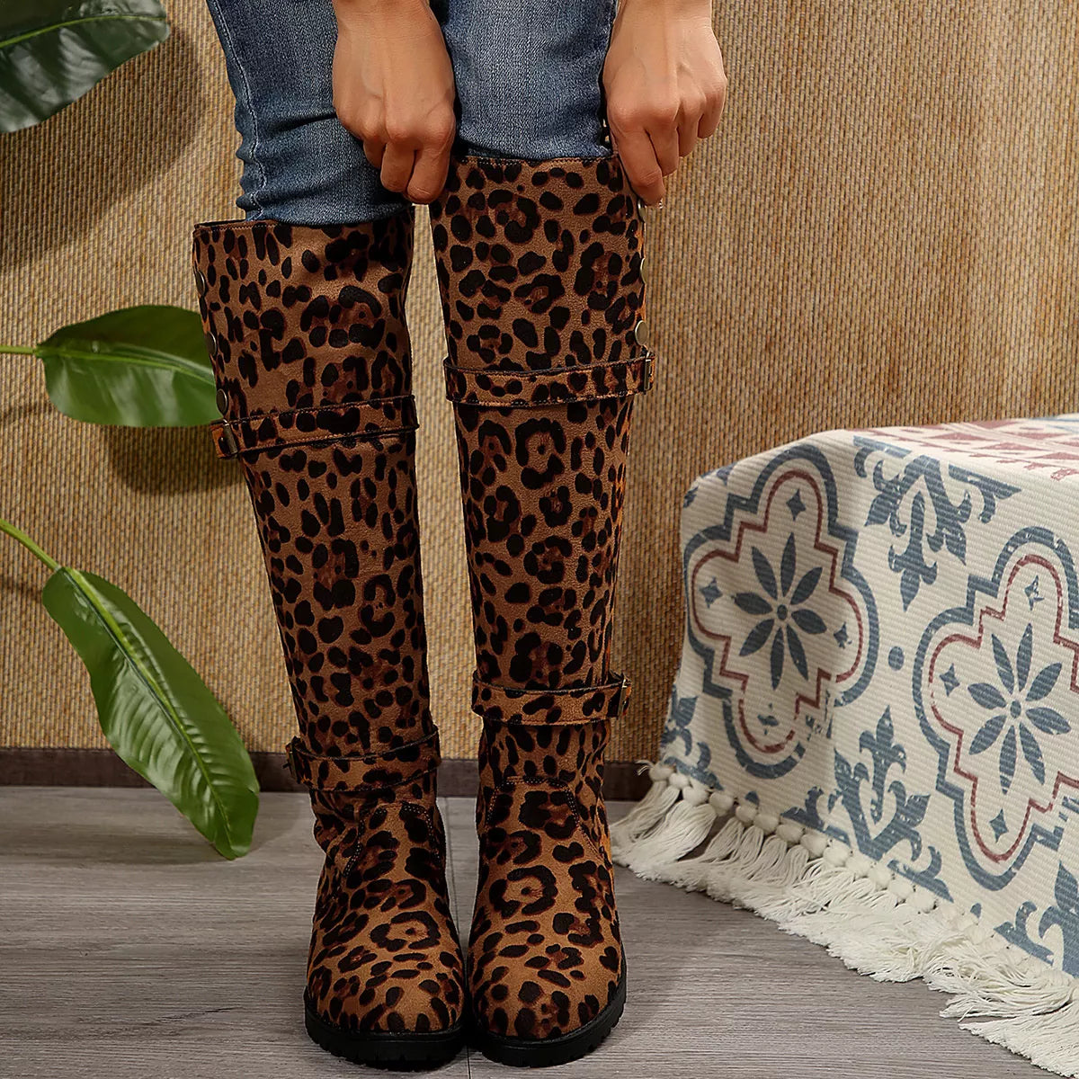 Leopard print mid block heel boots in PU leather and rubber material worn with jeans