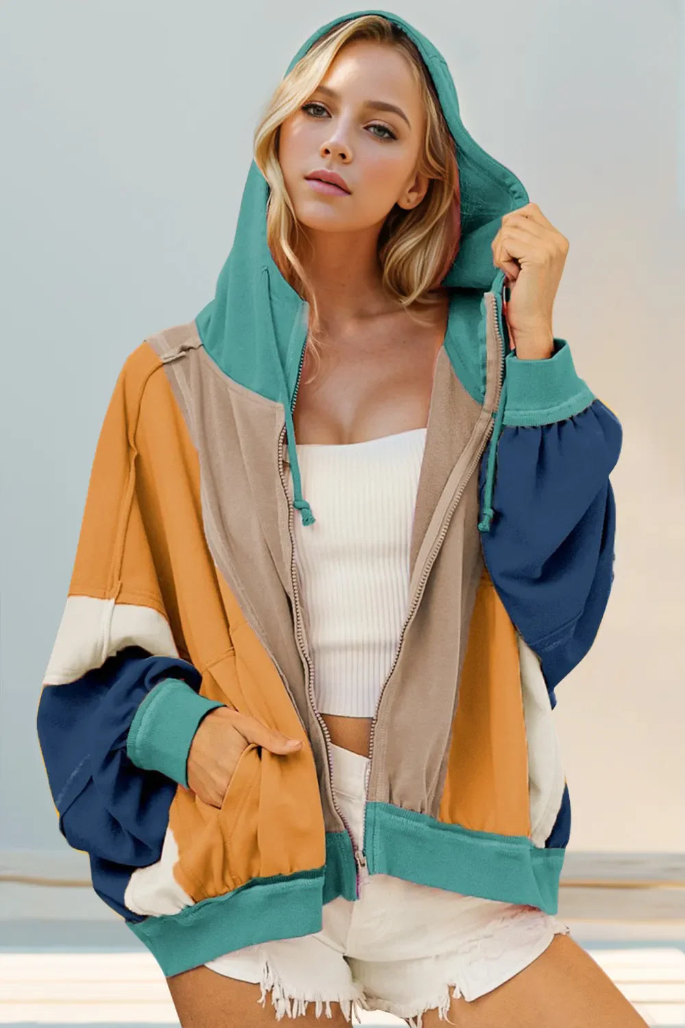 Full Size Color Block zip-up hoodie with drawstring hood and pockets, made of cotton-polyester blend, featuring exposed seams and color block design.