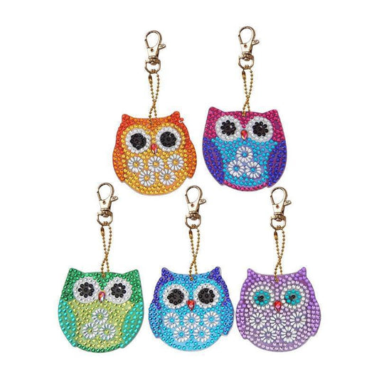 Colorful cartoon owl keychains with decorative pendant design.